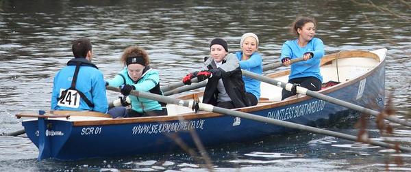 Coastal rowing race in action